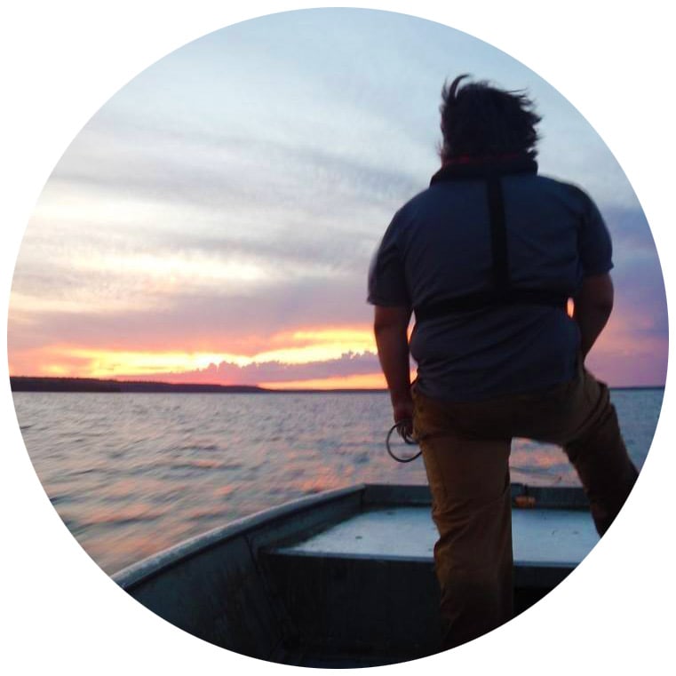 Man in boat on a lake staring at the sunset aofrc